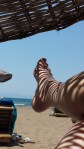 Admiring the sunshine and shadows on my legs on a beach in Turkey this year